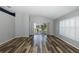 Spacious living area with wood-look floors, plantation shutters, and access to a back patio at 1633 Arbor Knoll Loop, Trinity, FL 34655