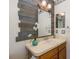 Small bathroom with wood vanity, single sink and decorative wall at 1633 Arbor Knoll Loop, Trinity, FL 34655