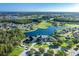 Aerial view of community, golf course, lake, and clubhouse at 1633 Arbor Knoll Loop, Trinity, FL 34655
