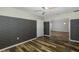 Bedroom with wood-look floors, patterned walls and access to another room at 1633 Arbor Knoll Loop, Trinity, FL 34655