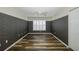 Bedroom with wood-look floors, patterned walls and ceiling fan at 1633 Arbor Knoll Loop, Trinity, FL 34655
