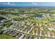 Aerial view of community with golf course and lake at 1633 Arbor Knoll Loop, Trinity, FL 34655