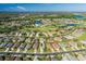 Aerial view of community with golf course and lake at 1633 Arbor Knoll Loop, Trinity, FL 34655