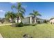 House exterior with palm trees and manicured lawn at 1633 Arbor Knoll Loop, Trinity, FL 34655