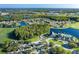 Aerial community view with golf course and lake at 1633 Arbor Knoll Loop, Trinity, FL 34655