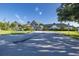 Community clubhouse exterior with landscaping and flag at 1633 Arbor Knoll Loop, Trinity, FL 34655