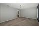 Well-lit bedroom with carpet, access to bathroom, and ceiling fan at 1633 Arbor Knoll Loop, Trinity, FL 34655
