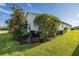 Landscaped yard with mature shrubs and green lawn at 1633 Arbor Knoll Loop, Trinity, FL 34655