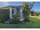 Outdoor screened patio with access to backyard and landscaping at 1633 Arbor Knoll Loop, Trinity, FL 34655