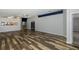 Living room with dark hardwood floors and view of kitchen at 1633 Arbor Knoll Loop, Trinity, FL 34655