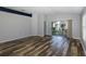 Bright living room featuring wood-look floors and sliding glass doors leading to a patio at 1633 Arbor Knoll Loop, Trinity, FL 34655