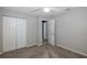 Well-lit bedroom featuring double-door closet and access to hallway at 1633 Arbor Knoll Loop, Trinity, FL 34655