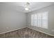 Spacious bedroom with neutral walls, ceiling fan, and window shutters at 1633 Arbor Knoll Loop, Trinity, FL 34655