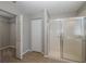 Bathroom with shower, tiled floors and closet access at 1633 Arbor Knoll Loop, Trinity, FL 34655