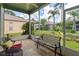 Screened porch with patio furniture and view of garden at 12200 Putter Green Ct, New Port Richey, FL 34654
