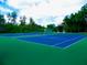 Two well maintained tennis courts at 12200 Putter Green Ct, New Port Richey, FL 34654