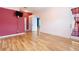 Bedroom with wood-look floors, neutral walls and door to exterior at 12200 Putter Green Ct, New Port Richey, FL 34654