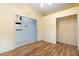 Bedroom with wood flooring and access to kitchen at 12200 Putter Green Ct, New Port Richey, FL 34654