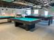 Community game room with billiard and shuffleboard tables at 12200 Putter Green Ct, New Port Richey, FL 34654