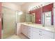 Bathroom with dual sinks, a shower, and updated vanity at 12200 Putter Green Ct, New Port Richey, FL 34654