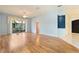 Spacious living room with wood-look floors and sliding glass doors leading to patio at 12200 Putter Green Ct, New Port Richey, FL 34654
