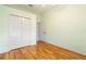 Bright bedroom with wood flooring and double door closet at 12200 Putter Green Ct, New Port Richey, FL 34654
