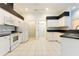 Bright kitchen with white cabinets and black countertops at 12200 Putter Green Ct, New Port Richey, FL 34654