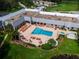 Aerial view of community pool with lounge chairs and surrounding landscaping at 12200 Putter Green Ct, New Port Richey, FL 34654