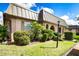 Tan condo with arched entryway and lush landscaping at 4129 Stratford Dr # 4129, New Port Richey, FL 34652