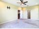 Spacious bedroom with carpet floors, a ceiling fan, and easy access to other rooms at 19492 Fort King Run, Brooksville, FL 34601