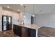 Kitchen with stainless steel appliances, granite counters, and an island with a sink and dishwasher at 19492 Fort King Run, Brooksville, FL 34601