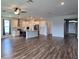 Spacious open-concept living room with adjacent kitchen and dining areas, and hardwood floors throughout at 19492 Fort King Run, Brooksville, FL 34601
