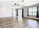 Open living room featuring hard surface flooring, ceiling fan, and bright windows at 19492 Fort King Run, Brooksville, FL 34601