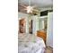 Bedroom featuring tile floors with a TV, mirrored walls, and access to the kitchen at 20861 Haulover Cv # C4, Lutz, FL 33558