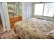Bright bedroom featuring tile floors, large window, closet, and mirrored wall accents at 20861 Haulover Cv # C4, Lutz, FL 33558
