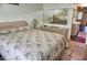 Comfortable bedroom with patterned bedding and mirrored wall at 20861 Haulover Cv # C4, Lutz, FL 33558