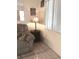 Cozy living room corner with a soft armchair, lamp, and window at 20861 Haulover Cv # C4, Lutz, FL 33558