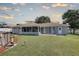 Spacious backyard featuring a pool and a well-maintained lawn at 3960 Lema Dr, Spring Hill, FL 34609