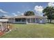Spacious backyard featuring a pool and a well-maintained lawn at 3960 Lema Dr, Spring Hill, FL 34609