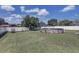 Expansive backyard with lush green lawn and an above ground swimming pool at 3960 Lema Dr, Spring Hill, FL 34609