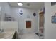 Bright bathroom featuring nautical decor and convenient storage shelves at 3960 Lema Dr, Spring Hill, FL 34609