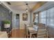 Cozy dining area featuring a chalkboard wall, stylish lighting, and a bright window at 3960 Lema Dr, Spring Hill, FL 34609
