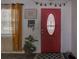 Inviting red front door with decorative glass, seasonal decor, and a charming entryway at 3960 Lema Dr, Spring Hill, FL 34609