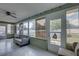 Bright sunroom with a couch and many windows overlooking the backyard at 3960 Lema Dr, Spring Hill, FL 34609