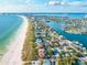 Coastal aerial view featuring white sandy beaches, turquoise waters, waterfront homes, and lush vegetation at 800 61St N St, St Petersburg, FL 33710