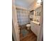Bathroom features a decorative shower curtain, vanity, and stylish decor at 800 61St N St, St Petersburg, FL 33710