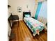 Bright bedroom featuring a twin bed, a desk area, and beachy decor with hardwood floors at 800 61St N St, St Petersburg, FL 33710