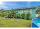 Exterior view of a home with lush landscaping and pops of tropical greenery at 800 61St N St, St Petersburg, FL 33710
