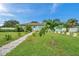 Well maintained lawn, stone path leading to light teal home at 800 61St N St, St Petersburg, FL 33710