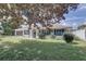 Single-story home with gray exterior, landscaping, and spacious yard at 3960 Lema Dr, Spring Hill, FL 34609